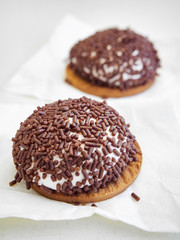 Konfeksiyon, Chocolate-coated marshmallow, typical Turkish cookies, over a white cooking paper. Also know as Tunnock, teacake from Scotland.