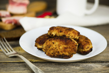 meat fried cutlets on a plate on a wooden board