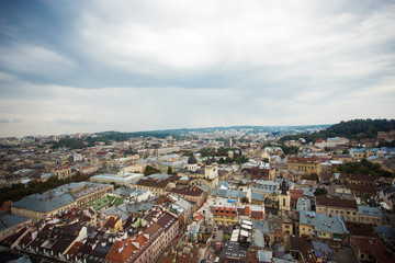 Aerial view old european city with rainy clouds on background