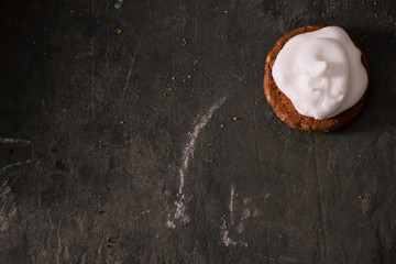 Cookies with cream cheese topping on rustic wooden table