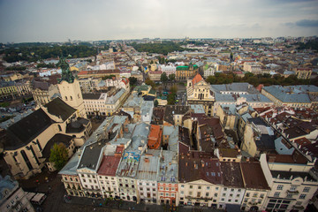 Fototapeta premium Aerial view old european city with rainy clouds on background