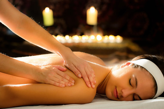 Young woman relaxing at ayurveda massage spa.