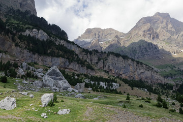The mountains and the massif along the green path to the Piedrafita de Jaca lake in the aragonese Pyrenees mountains