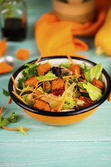 salad of fresh vegetables and baked pumpkin in a plate