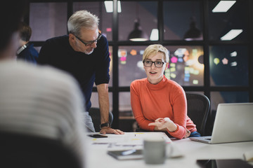 Coworkers working late in an office
