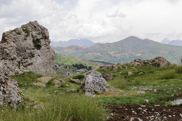 The mountains and the massif along the green path to the Piedrafita de Jaca lake in the aragonese Pyrenees mountains