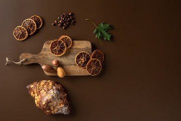 dough roll of dough on a wooden brown background Nuts, oranges, coffee beans