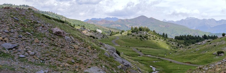 Fototapeta na wymiar The mountains and the massif along the green path to the Piedrafita de Jaca lake in the aragonese Pyrenees mountains