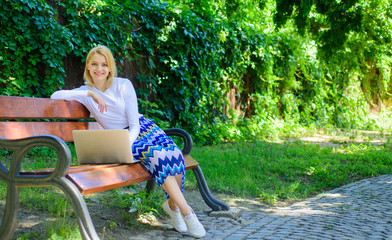 Freelance lifestyle advantages. Working outdoors. Casual and part time outdoor jobs. Girl sit bench...