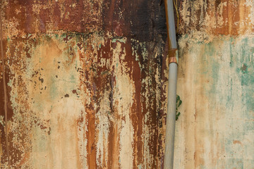 Peeled Paint on Moldy Concrete Wall with Old Pipe - Vintage Texture/ Orange and Brown