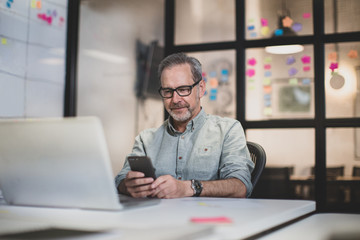 Mature male working late in an office