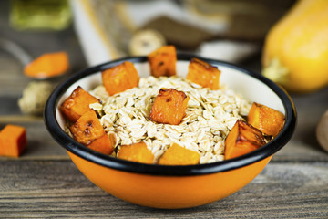 oatmeal porridge with stewed pumpkin in a plate
