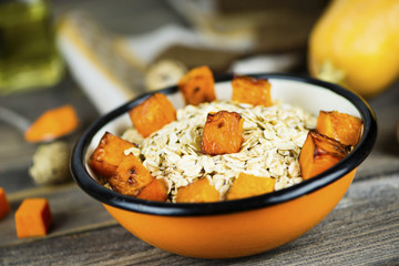 oatmeal porridge with stewed pumpkin in a plate
