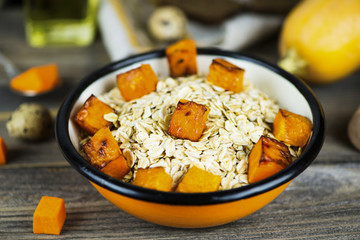 oatmeal porridge with stewed pumpkin in a plate