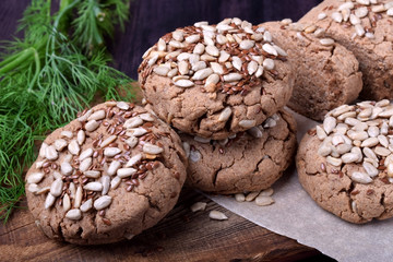 Wholegrain gluten-free buckwheat bread with sunflower and flax seeds on a wooden board