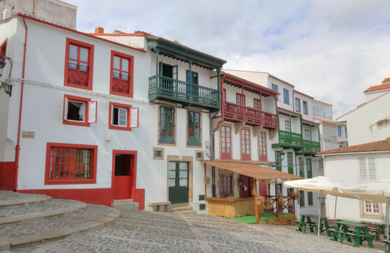 The Fern&aacute;n P&eacute;rez de Andrade squale (plaza Fern&aacute;n P&eacute;rez de Andrade), with red and green windows and balconies and white walls, in the Betanzos city in Galicia, Spain