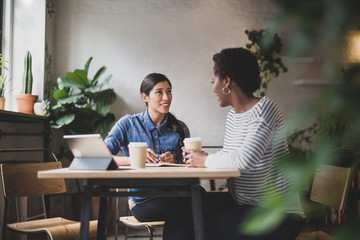 Female entrepreneurs having a meeting in a cafe