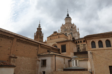 Fototapeta na wymiar The Nuestra Señora de la Huerta gothic and mudejar cathedral dome and bell tower in a cloudy, autumn day in Tarrazona, Aragon, Spain