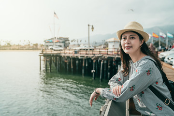 woman leaning on the guardrail on the wharf