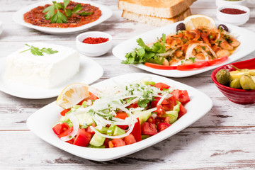 Various Turkish Appetizers from Onion, Tomato, Lettuce, Pickle, Yoghurt on White Wooden Background