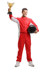 Racer standing and holding a helmet and a gold trophy cup