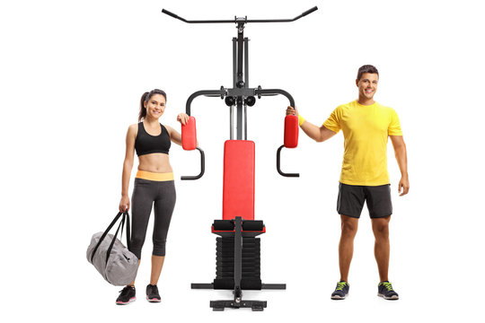 Young Man And Woman With A Multifunctional Exercise Machine