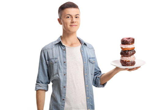 Teenage boy holding a plate of donuts