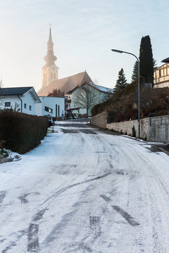 slippery snowy street leading to church