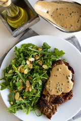 steak with arugula and green peppercorn sauce