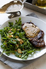 steak with arugula and green peppercorn sauce