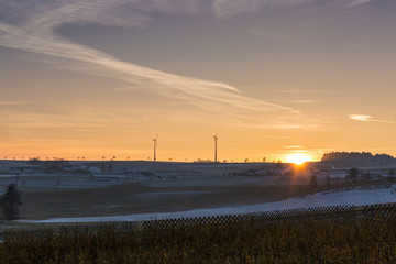 Wind mills at sunset in winter