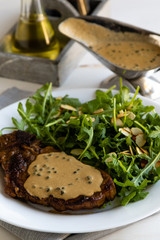 steak with arugula and green peppercorn sauce