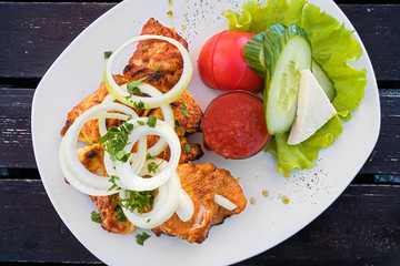 Delicious grilled shashlik with adjika and vegetables. Top view.