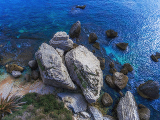 Aerial view of giant boulders on a tropical stone beach