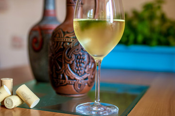 a glass of wine and bottles in perspective