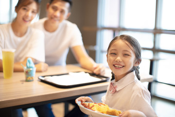 Happy family  enjoying dinner in restaurant.