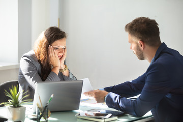 Businessman Showing Document To Female Employee