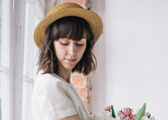 Сute girl in hat smilling in vintage apartment