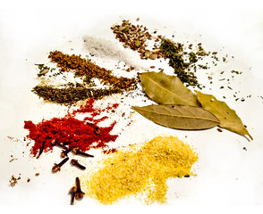Arrangement with spices and seeds - salt, pepper bay leaves, cloves, paprika, coriander