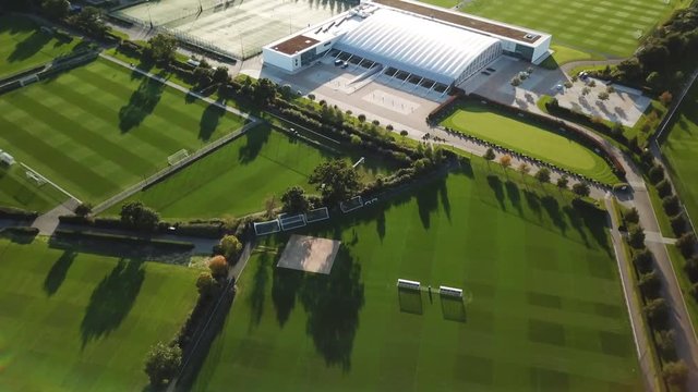 erial Tuttenham scocer footbal training facility England. Near Tottenham Hotspur Football Club training and practice fields. Green game areas and residential streets in urban suburbs.