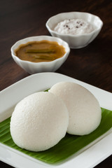 Indian idly with chutney and sambar - Fresh steamed Indian Idly (Idli / rice cake) arranged on...