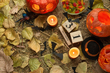 Background of Halloween with pumpkin candles and ghost, and the number October 31