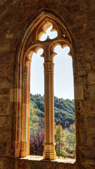 Fototapeta na wymiar The Gothic pointed arch window with decorations at the entrance of the Saint Blaise church (Iglesia de San Blas) in the Anento small town, in Aragon province, Spain