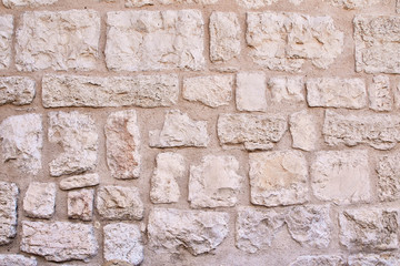 ancient masonry of large stones of the wall in the historical part of the city of Jerusalem