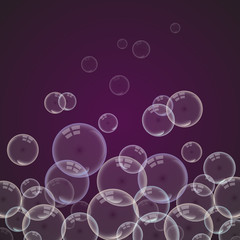 Isolated colorful realistic shampoo bubbles with a reflection of a transparent dark background.