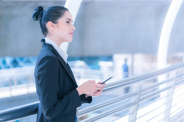 Fototapeta premium Business woman using phone outdoor modern city urban life concept