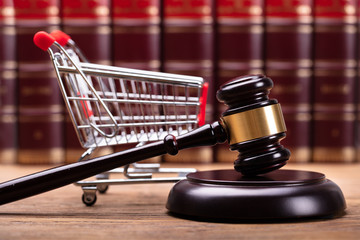 Close-up Of Gavel And Shopping Cart