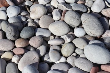 Smooth grey and white pebbles on beach