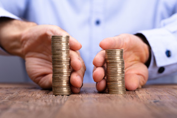 Person's Hand Holding Stack Of Coins