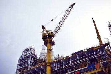 Crane during work on oil and gas platform.